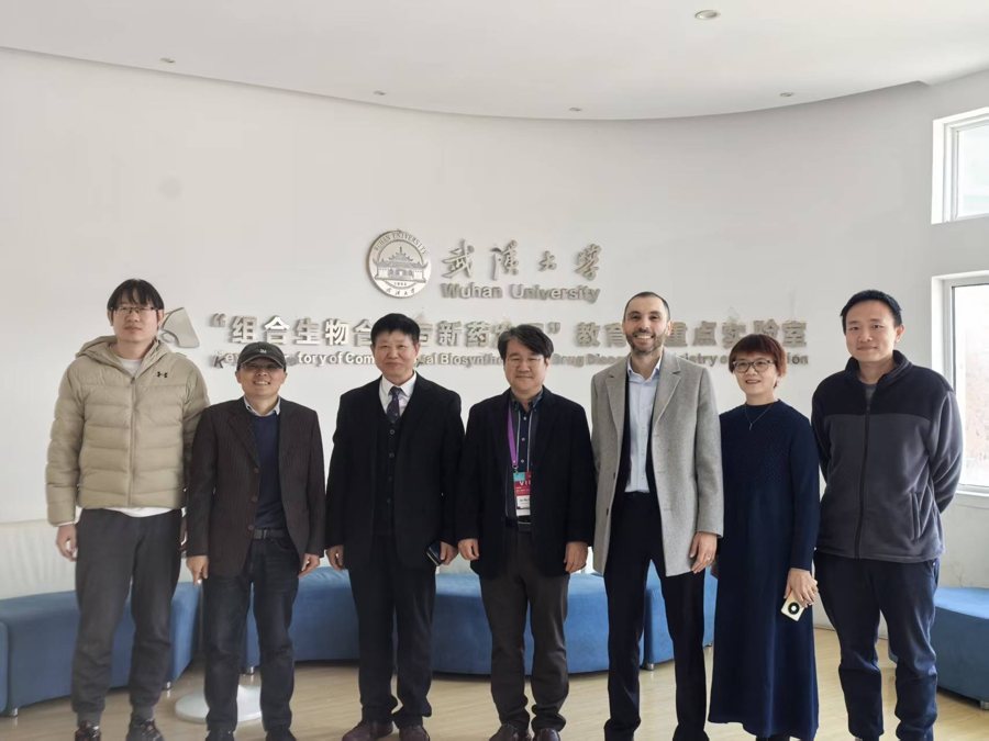 Dr Haithem Afli presenting at a lectern at Wuhan University in 2025.